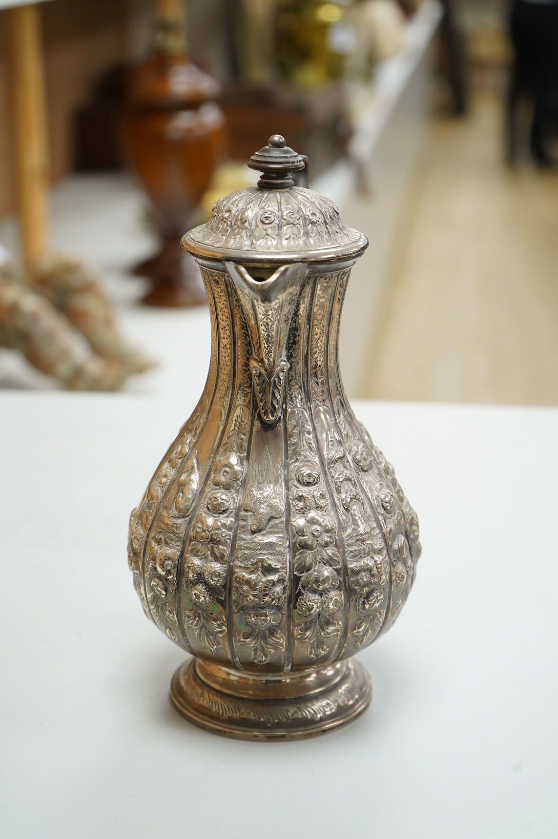 A late Victorian embossed silver hot water jug, of baluster form, F.B. Thomas & Co, London, 1892, height 25.5cm, gross weight 18.4oz.